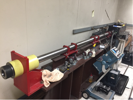 Setup of the 20 mm gun in the Shockwave Laboratory in GPS for recovery experiments. The length of the barrel is ~7 feet. The laser is used to measure the projectile velocity.