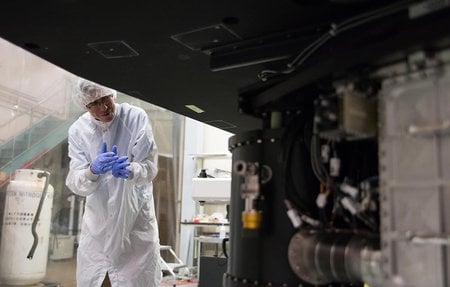 Chris Martin, the principal investigator of the Keck Cosmic Web Imager, inspects the instrument in a clean room at Caltech. 