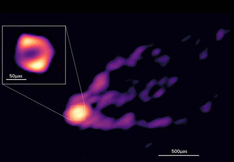 This is the shadow of the black hole cast on its outburst of pure energy. 