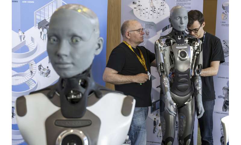 UN tech agency rolls out human-looking robots for questions at a Geneva news conference