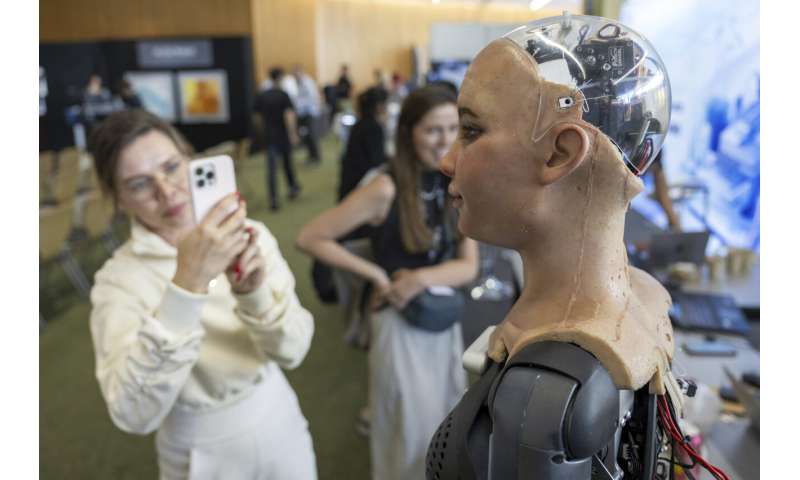 UN tech agency rolls out human-looking robots for questions at a Geneva news conference