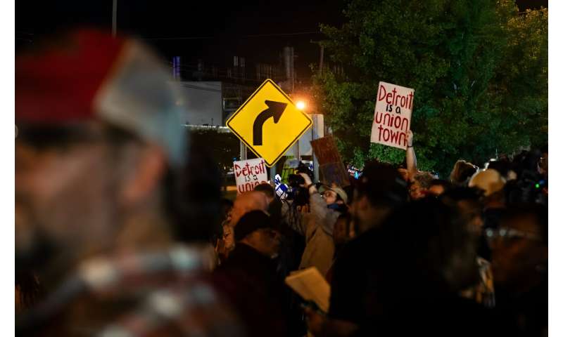 Members of the UAW (United Auto Workers) picket and hold signs outside of the UAW Local 900 headquarters across the street from the Ford Assembly Plant in Wayne, Michigan on September 15, 2023