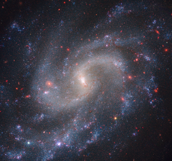 Combined observations from NASA’s NIRCam (Near-Infrared Camera) and Hubble’s WFC3 (Wide Field Camera 3) show spiral galaxy NGC 5584, which resides 72 million light-years away from Earth. Among NGC 5584’s glowing stars are pulsating stars called Cepheid variables and Type Ia supernova, a special class of exploding stars. Astronomers use Cepheid variables and Type Ia supernovae as reliable distance markers to measure the universe’s expansion rate. 