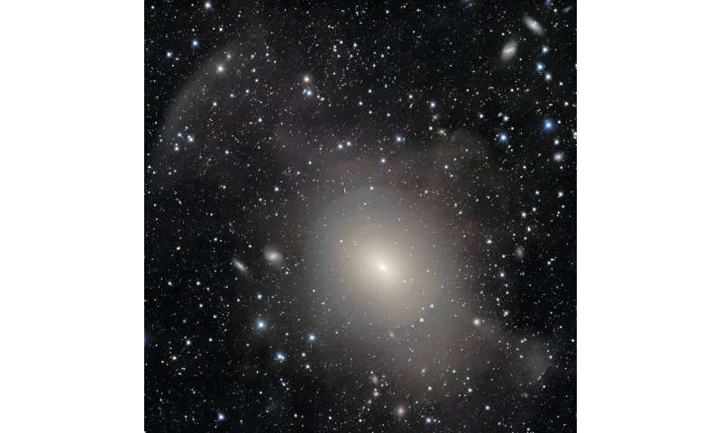 DECam captures the stunning layers of shell galaxy NGC 3923 and nearby gravitational lensing