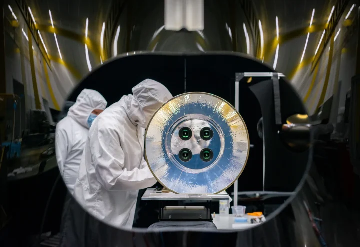 Scientists prepare the optical assembly for AWE for launch in a clean room at Space Dynamics Laboratory facilities. 