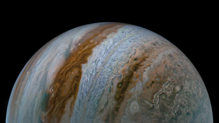 NASA’s Juno captured this view of Jupiter during the mission’s 54th close flyby of the giant planet on Sept. 7. The image was made with raw data from the JunoCam instrument that was processed to enhance details in cloud features and colors.