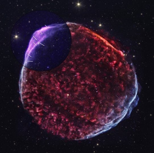 This new image of supernova remnant SN 1006 combines data from NASA’s Imaging X-ray Polarimetry Explorer and NASA’s Chandra X-ray Observatory. The red, green, and blue elements reflect low, medium, and high energy X-rays, respectively, as detected by Chandra. The IXPE data, which measures the polarization of the X-ray light, is show in purple in the upper left corner, with the addition of lines representing the outward movement of the remnant’s magnetic field.