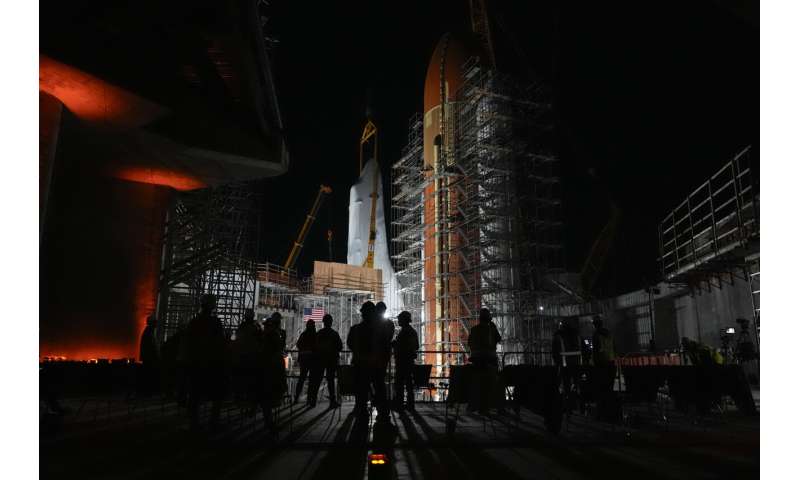 Space Shuttle Endeavour hoisted for installation in vertical display at Los Angeles science museum