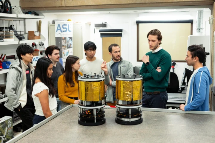 CAESAR researchers discuss the robotic free-flyer platform, which uses air bearings to hover on a granite table and simulate a frictionless zero gravity environment.