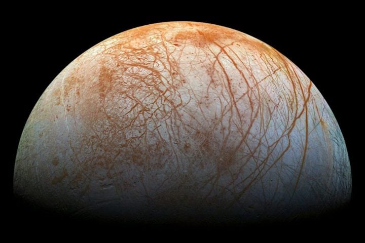 This image shows red streaks across the surface of Europa, the smallest of Jupiter’s four large moons. The upcoming Europa Clipper mission will send instruments to investigate this moon. New research shows that one of these instruments destined for the next mission could find traces of a single cell in a single ice grain ejected from the planetary body’s interior.