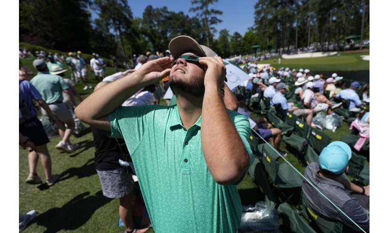 A total solar eclipse races across North America as clouds part along totality