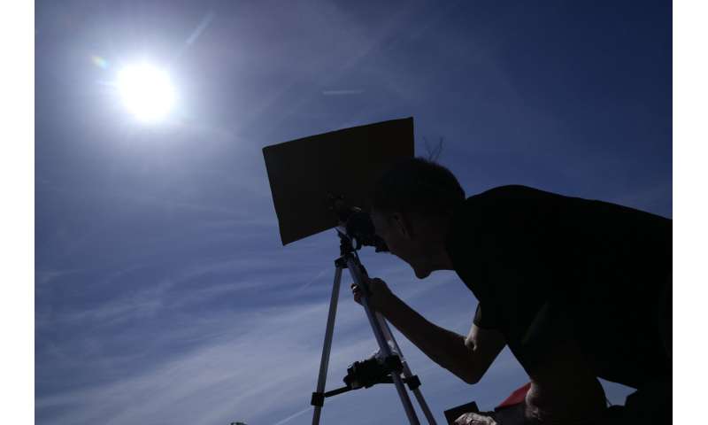 A total solar eclipse races across North America as clouds part along totality