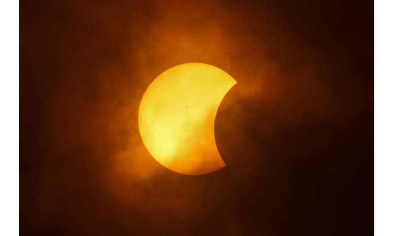 A total solar eclipse races across North America as clouds part along totality