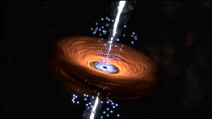 Artist's impression of the bright core region of a quasar, an active galaxy. The supermassive black hole in the centre is surrounded by a bright disk of gas and dust. The dust component further out can obscure the view of the interior and shines predominantly in the mid-infrared range, light that can be analysed by the James Webb Space Telescope. A bundled, high-energy particle beam protrudes into space from the immediate vicinity of the black hole perpendicular to the disc.