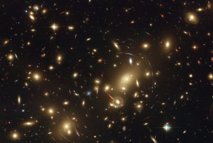 Image of Abell 2218, a dense galactic cluster approximately 2 billion light years from Earth. 