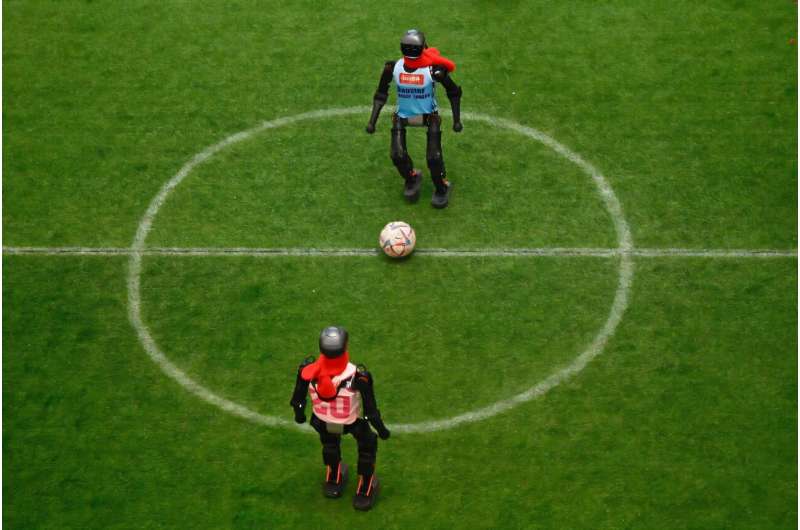 Robots vie for the ball during an exhibition football match at a fair in Beijing during China's week-long Lunar New Year holidays