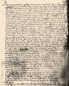 Yellowed page of manuscript with small, inked script