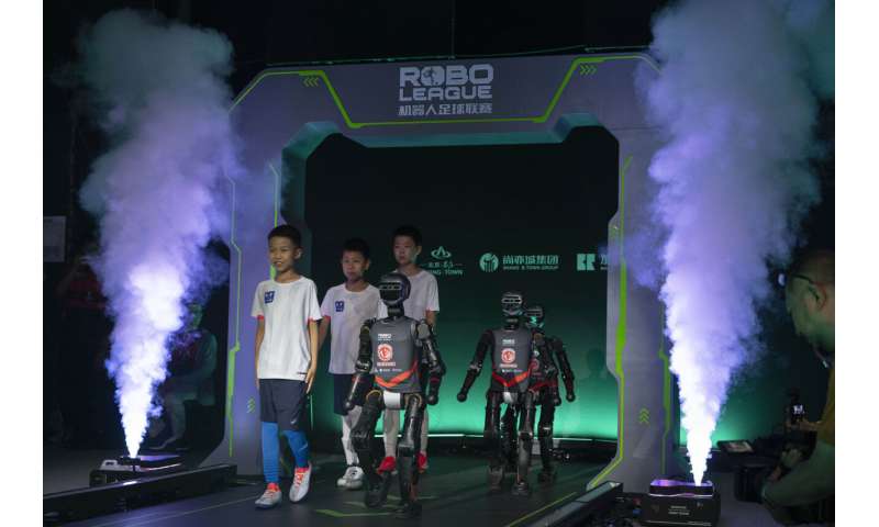 Photos show how humanoid robots captivate fans in China by playing a soccer match