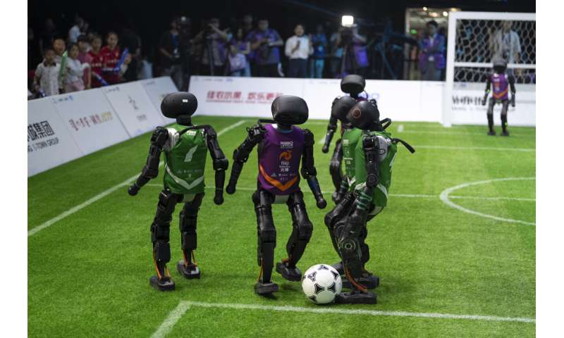 Photos show how humanoid robots captivate fans in China by playing a soccer match