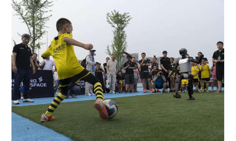 Photos show how humanoid robots captivate fans in China by playing a soccer match