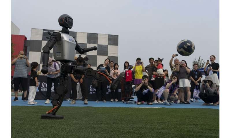 Photos show how humanoid robots captivate fans in China by playing a soccer match