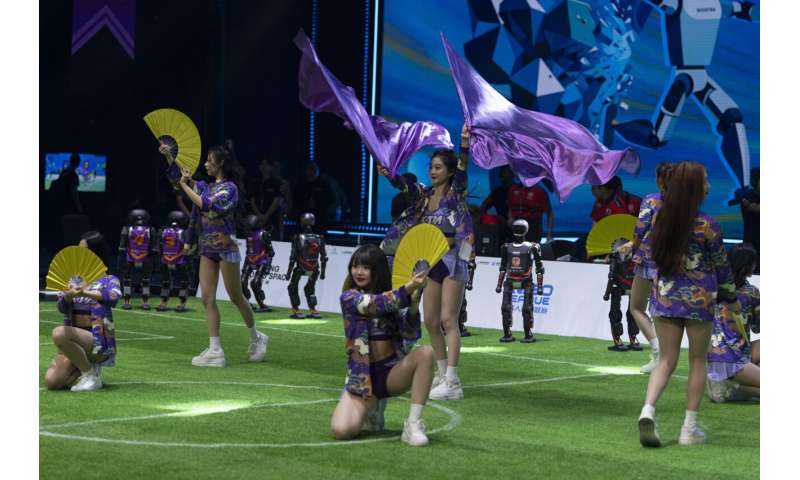 Photos show how humanoid robots captivate fans in China by playing a soccer match