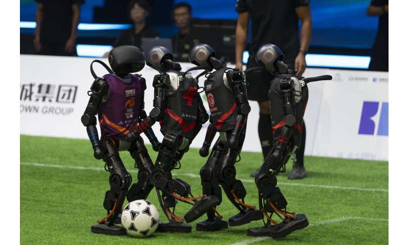 Photos show how humanoid robots captivate fans in China by playing a soccer match