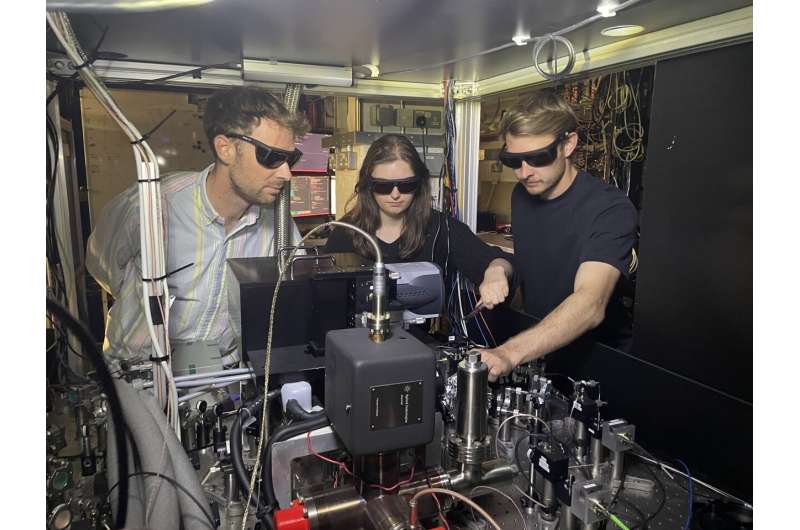 The Oxford researchers with the experimental equipment, in the Clarendon Laboratory, Department of Physics, University of Oxford. From left to right: Dr. Mario Gely, Molly Smith, Aaron Leu. Credit: Adam Martinez Oxford physicists set new world record for qubit operation accuracy