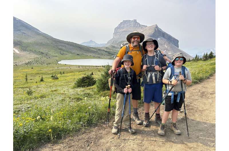 This undated photo shows the Campbell family, wearing sun protection shirts and hats, posing for a photo during a hike in the Rocky Mountains near their Calgary, Alberta home, Credit: Lynn Campbell via AP Beat the heat with these cooling gadgets and wearables