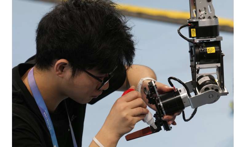 Photos of Beijing's World Humanoid Robot Games show how a human touch is still needed