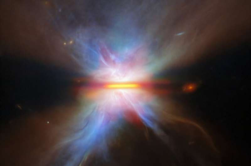 A detailed view of IRAS 16594-4656 captured by the James Webb Space Telescope. A bright central region is bisected by a thin, horizontal line of dark dust. Symmetrical lobes of glowing gas extend above and below, with soft blue, purple, and orange hues blending outward into surrounding space. Credit: ESA/Webb, NASA & CSA, M. Villenave et al. Image: Dusty wisps round a dusty disk