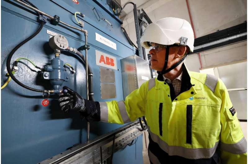 Statkraft's Guy Nicholson stands by a flywheel at the firm's new Greener Grid Park in Liverpool, one of the projects contracted by the city to keep the lights on. Statkraft's Guy Nicholson stands by a flywheel at the firm's new Greener Grid Park in Liverpool, one of the projects contracted by the city to keep the lights on