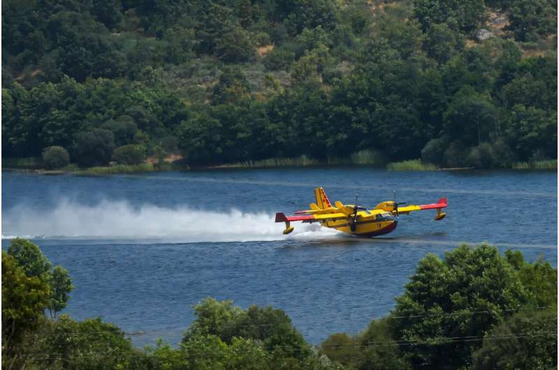 Canadair firefighting planes scoop up water to fight wildfires, as seen here in a 2025 firefight in Portugal