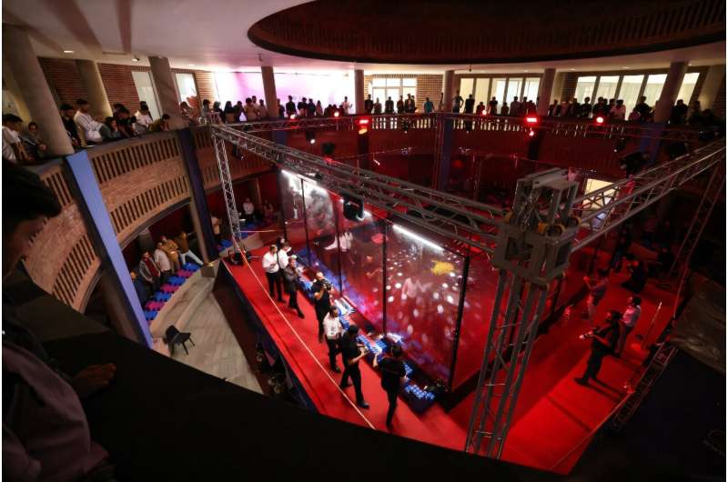 Engineering students and guests watch robots battle it out at Iran's Tech Olympics. Engineering students and guests watch robots battle it out at Iran's Tech Olympics