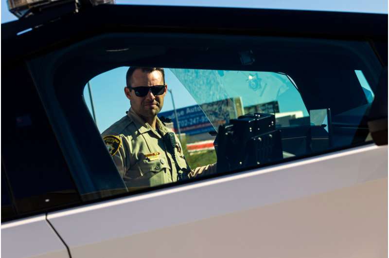 A member of the Las Vegas Police Department inspects a Tesla Cybertruck, part of the department's fleet of vehicles, in Las Vegas on Tuesday Oct, 28th 2025. Credit: AP Photo/Ty ONeil Nation's largest fleet of police Cybertrucks to patrol Las Vegas