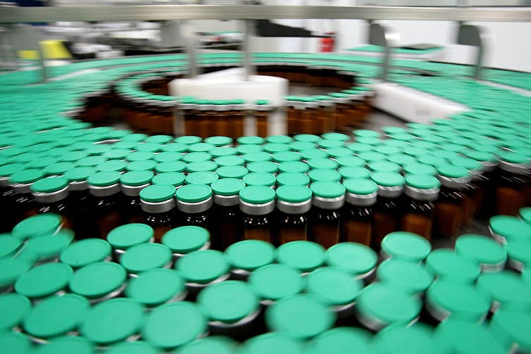 Large assortment of vials in three concentric circles on a manufacturing line